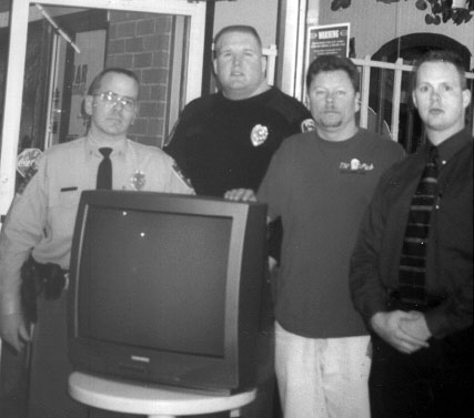 Police present TV set to raffle winner